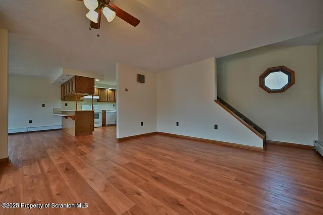 a view of a room with wooden floor
