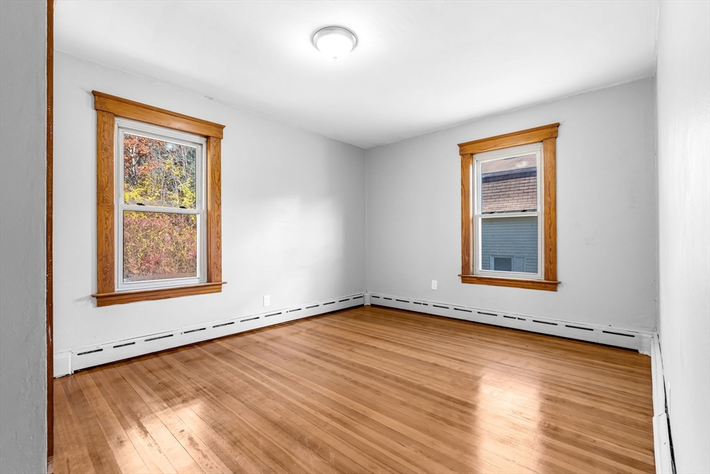 105 Conant Street Gardner, MA 01440 - Photo 13 of 19 a view of an empty room with a window and wooden floor