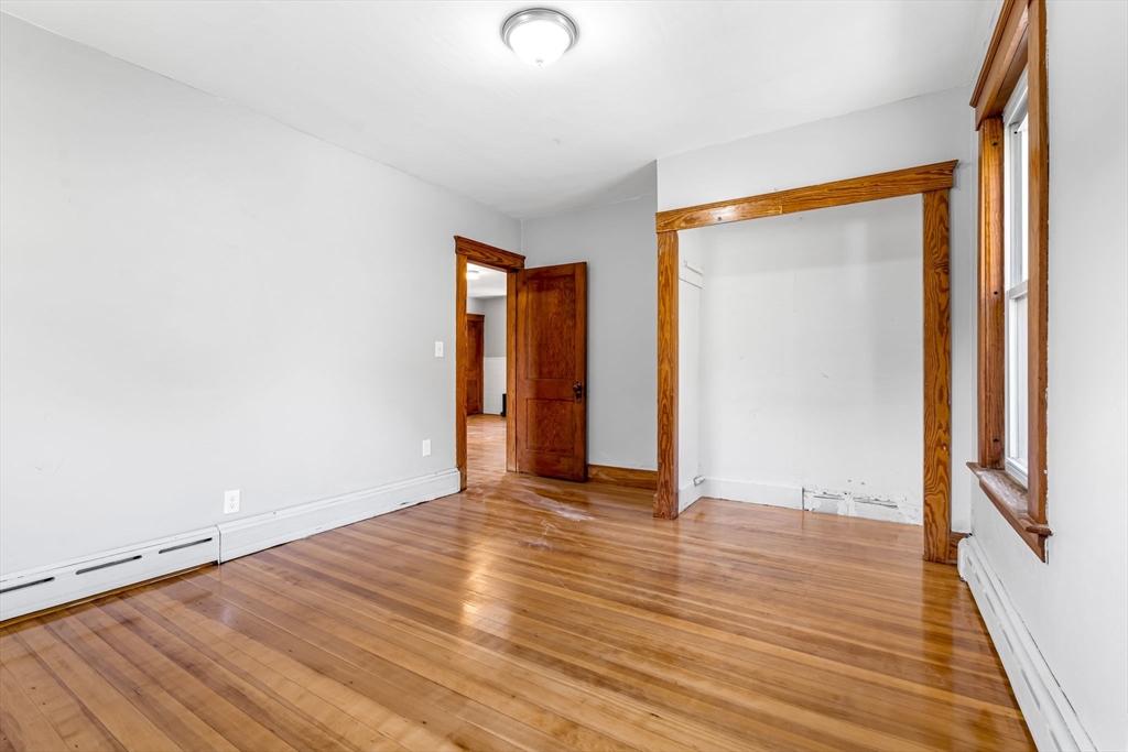105 Conant Street Gardner, MA 01440 - Photo 16 of 19 a view of an empty room with wooden floor and a window