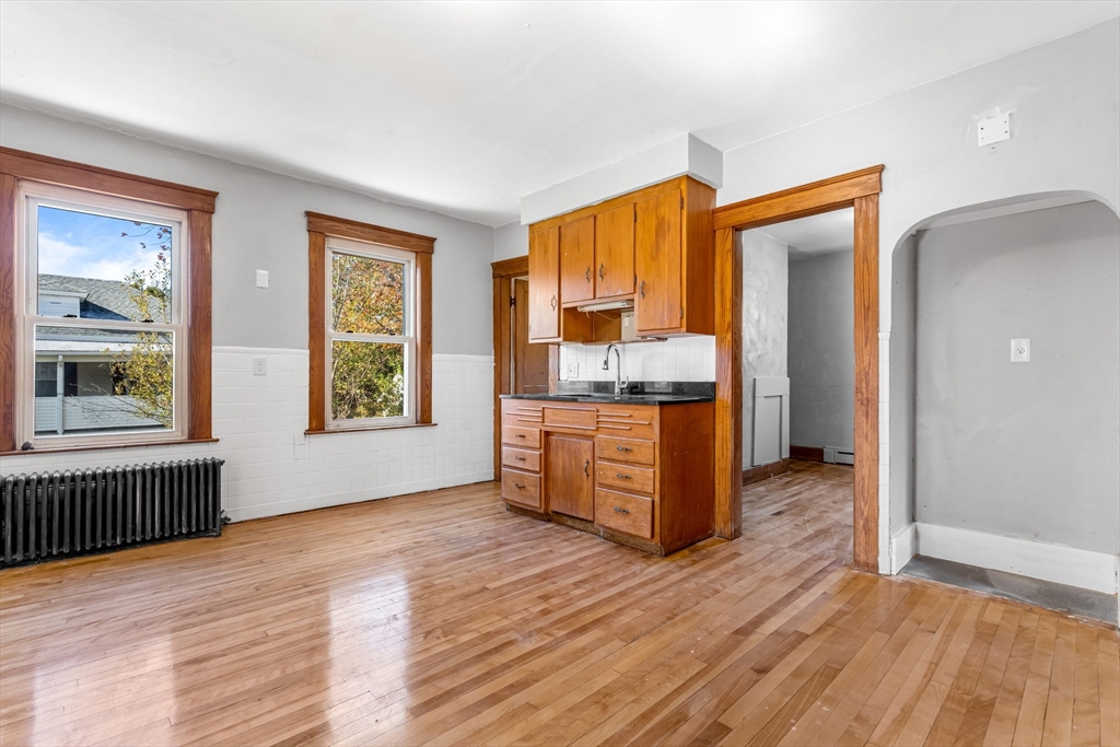 105 Conant Street Gardner, MA 01440 - Photo 18 of 19 a room with kitchen island wooden floor and window