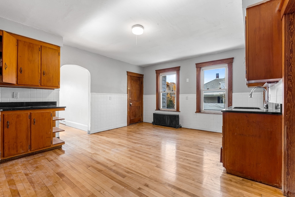 105 Conant Street Gardner, MA 01440 - Photo 19 of 19 a view of an empty room with window and wooden floor