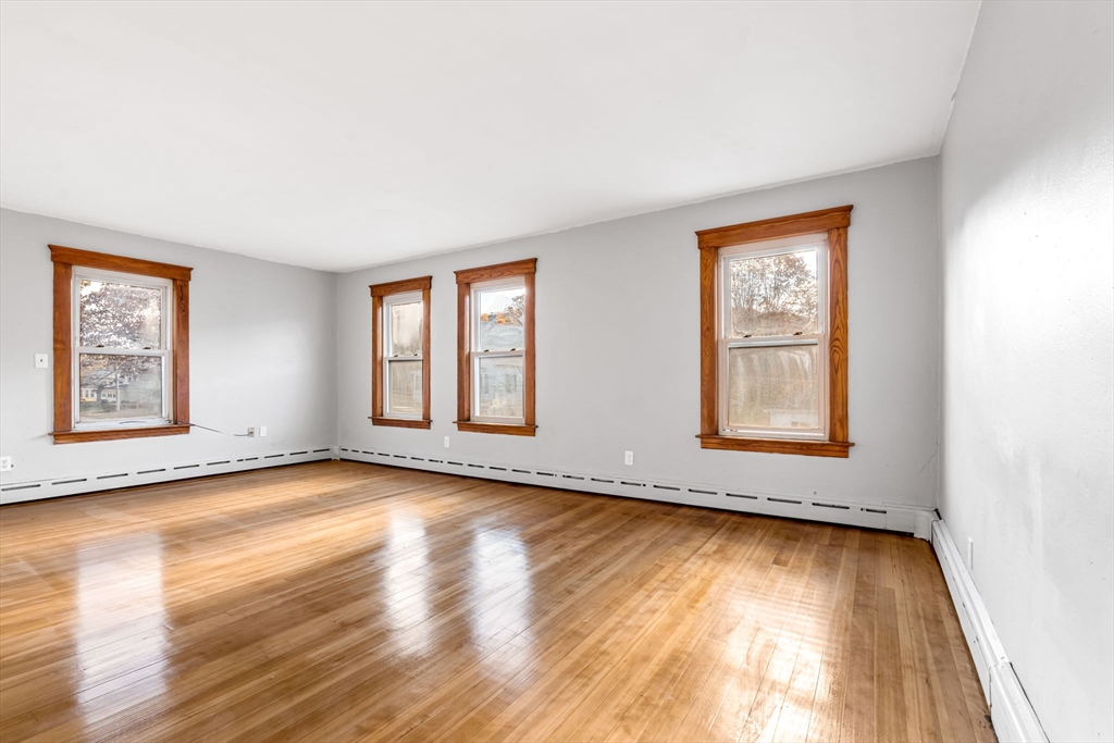 105 Conant Street Gardner, MA 01440 - Photo 8 of 19 an empty room with wooden floor and windows