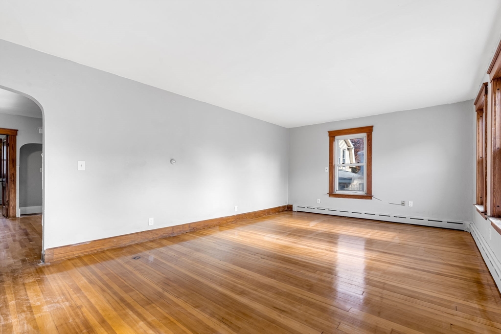 105 Conant Street Gardner, MA 01440 - Photo 9 of 19 a view of an empty room with wooden floor and a window