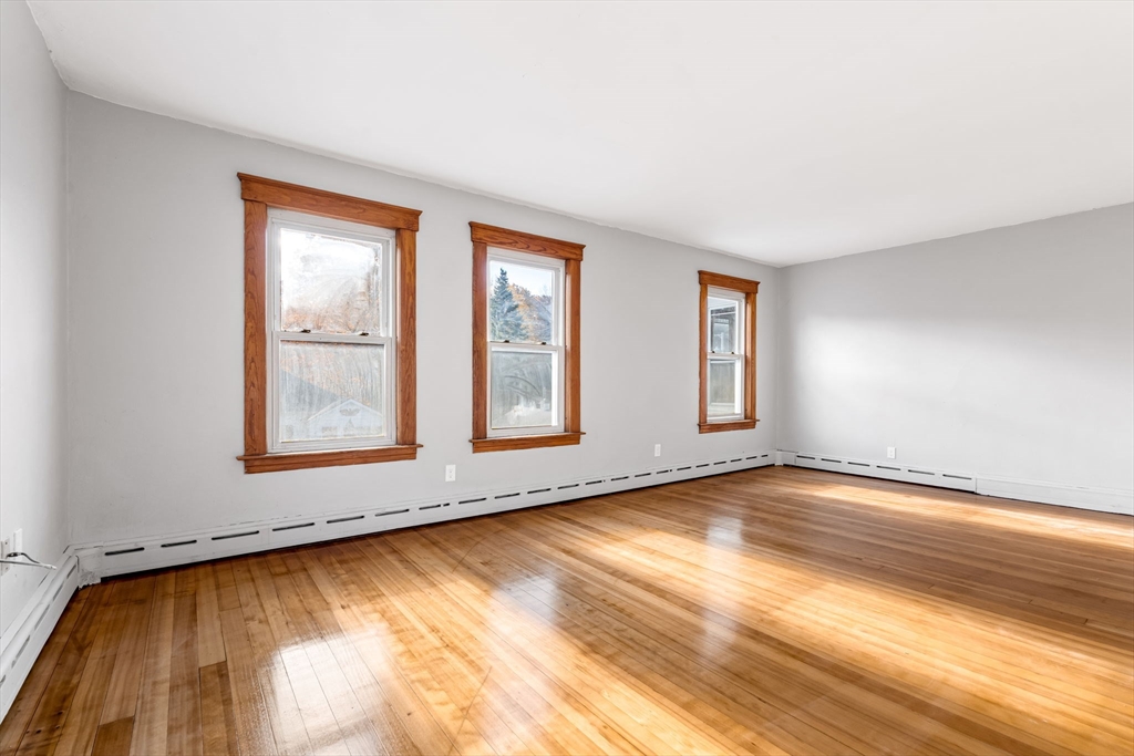 105 Conant Street Gardner, MA 01440 - Photo 10 of 19 a view of an empty room with wooden floor and a window