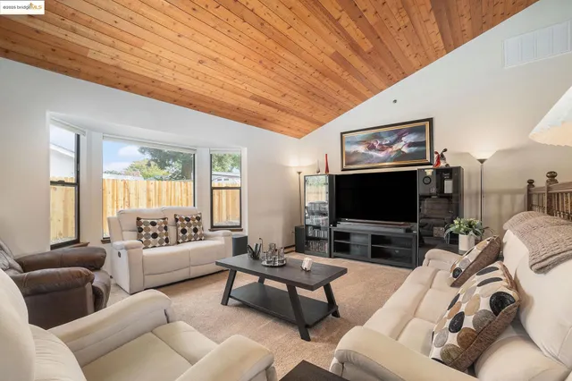 a view of a livingroom with furniture and a flat screen tv