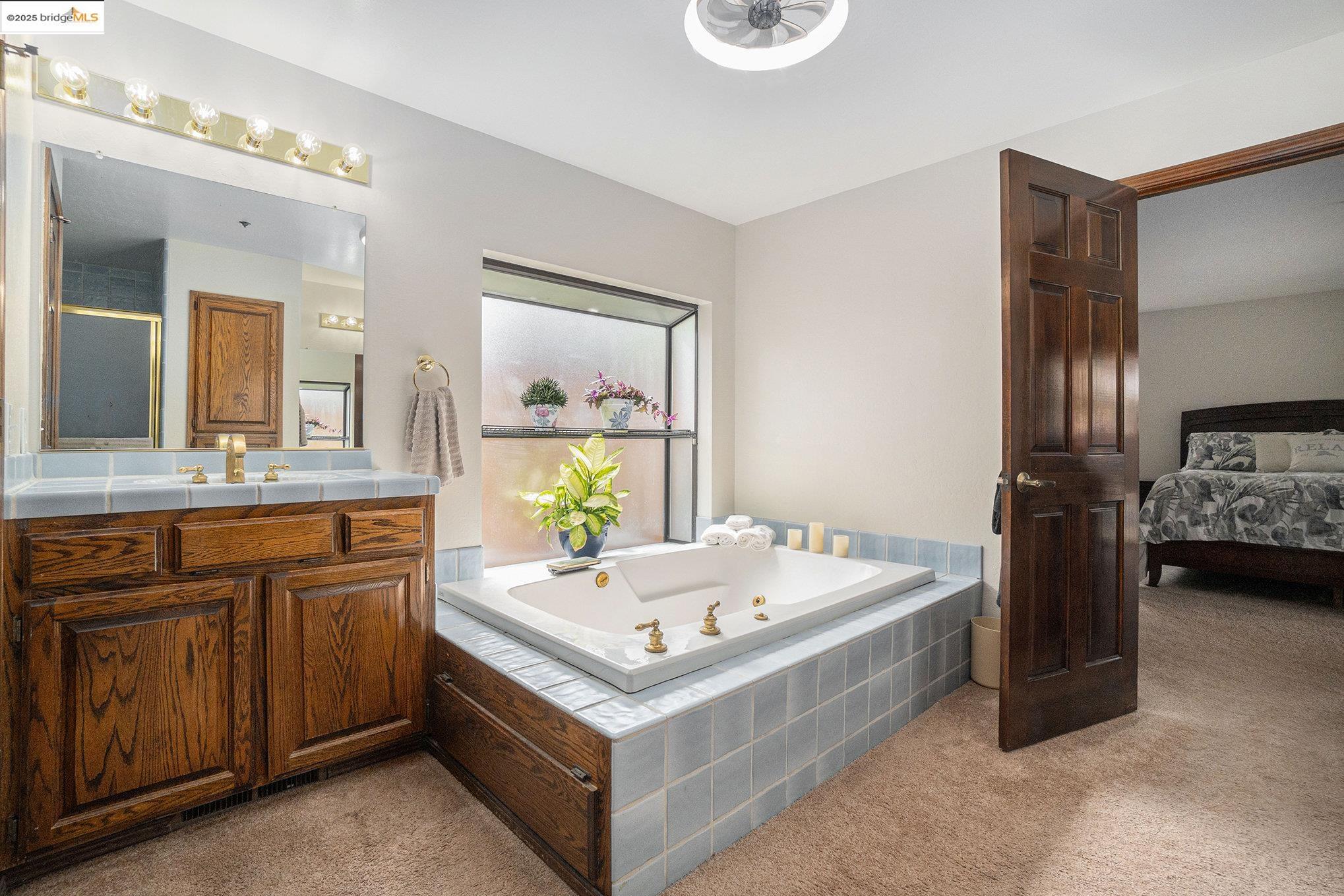 3622 Delancey Lane Concord, CA 94519 - Photo 23 of 32 a spacious bathroom with a tub sink and mirror