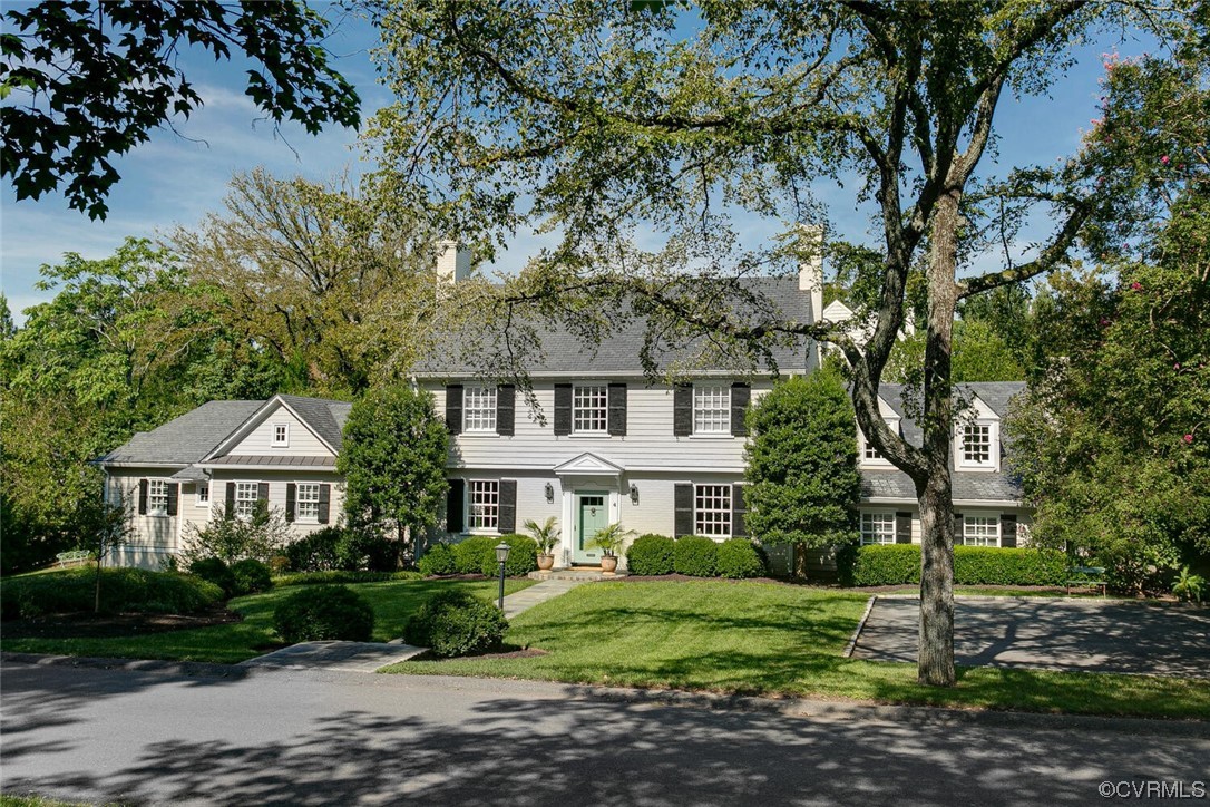 a front view of a house with a garden