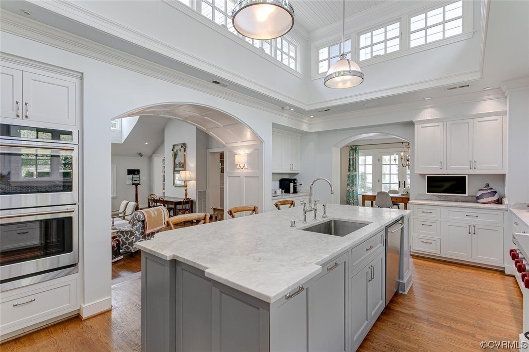 4 South Wilton Road Richmond, VA 23226 - Photo 10 of 49 a kitchen with stainless steel appliances granite countertop a sink dishwasher and white cabinets with wooden floor