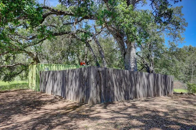 a wooden fence with trees in the background