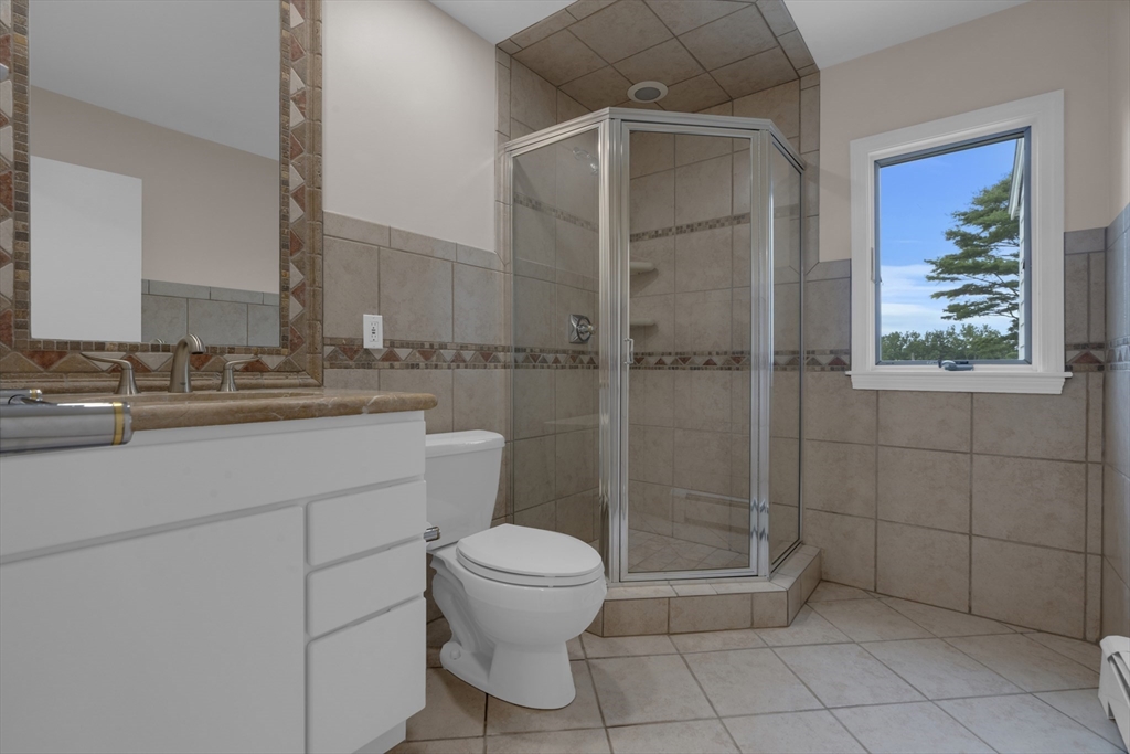 15 Marcellus Drive Newton, MA 02459 - Photo 18 of 27 a bathroom with a toilet sink and shower