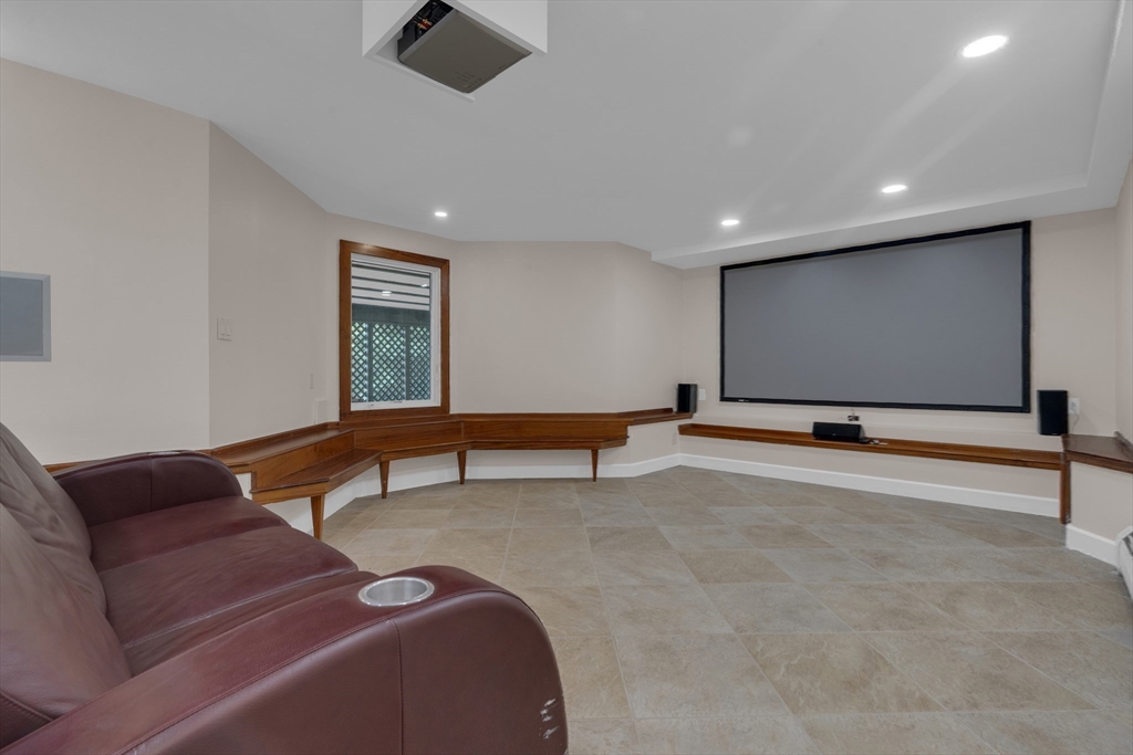15 Marcellus Drive Newton, MA 02459 - Photo 19 of 27 a living room with projector and a projector