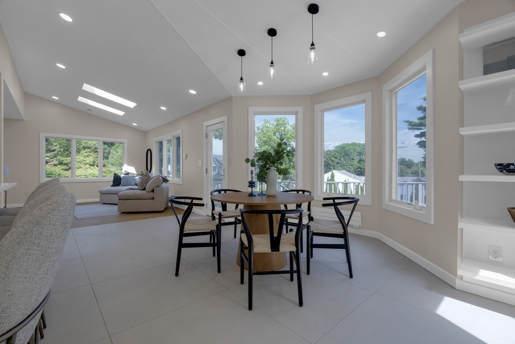 15 Marcellus Drive Newton, MA 02459 - Photo 3 of 27 a view of a dining room with furniture and a potted plant