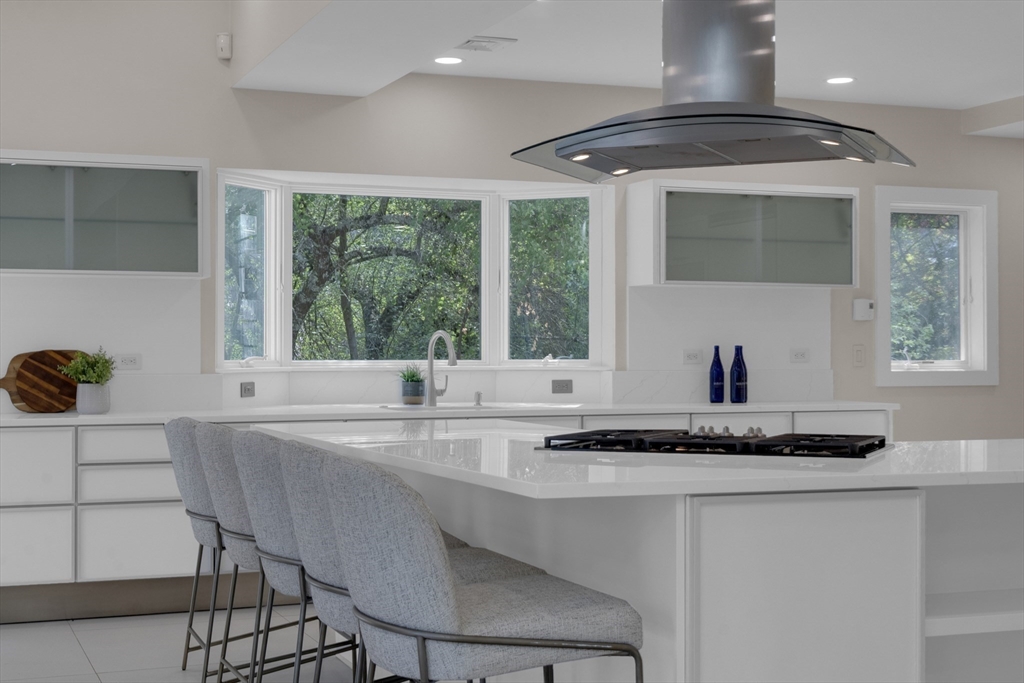 15 Marcellus Drive Newton, MA 02459 - Photo 6 of 27 a kitchen with stainless steel appliances granite countertop a sink and a stove
