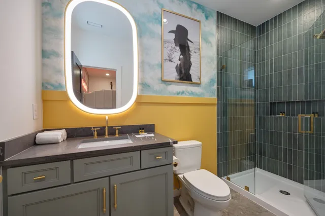 a bedroom with a bed and a large mirror