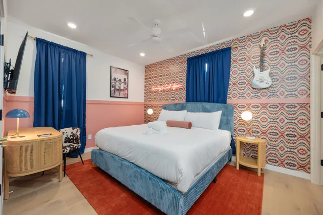 a bedroom with a bed and a large window