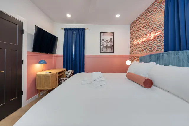 a bedroom with a bed and a flat screen tv