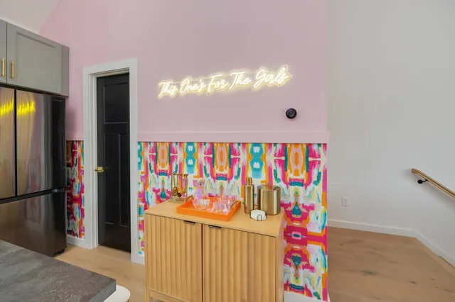 a view of a balcony with chairs and a potted plant