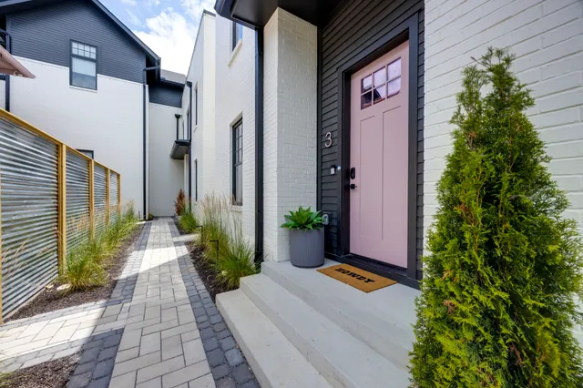 a view of a hallway with two couches and a flat screen tv