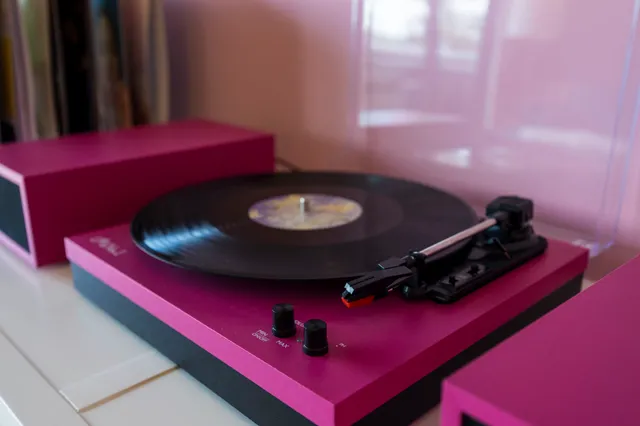 a bedroom with a bed and a lamp on dresser