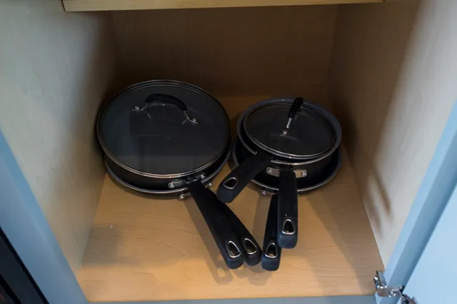 a white bed sitting in a bedroom next to a wooden wall