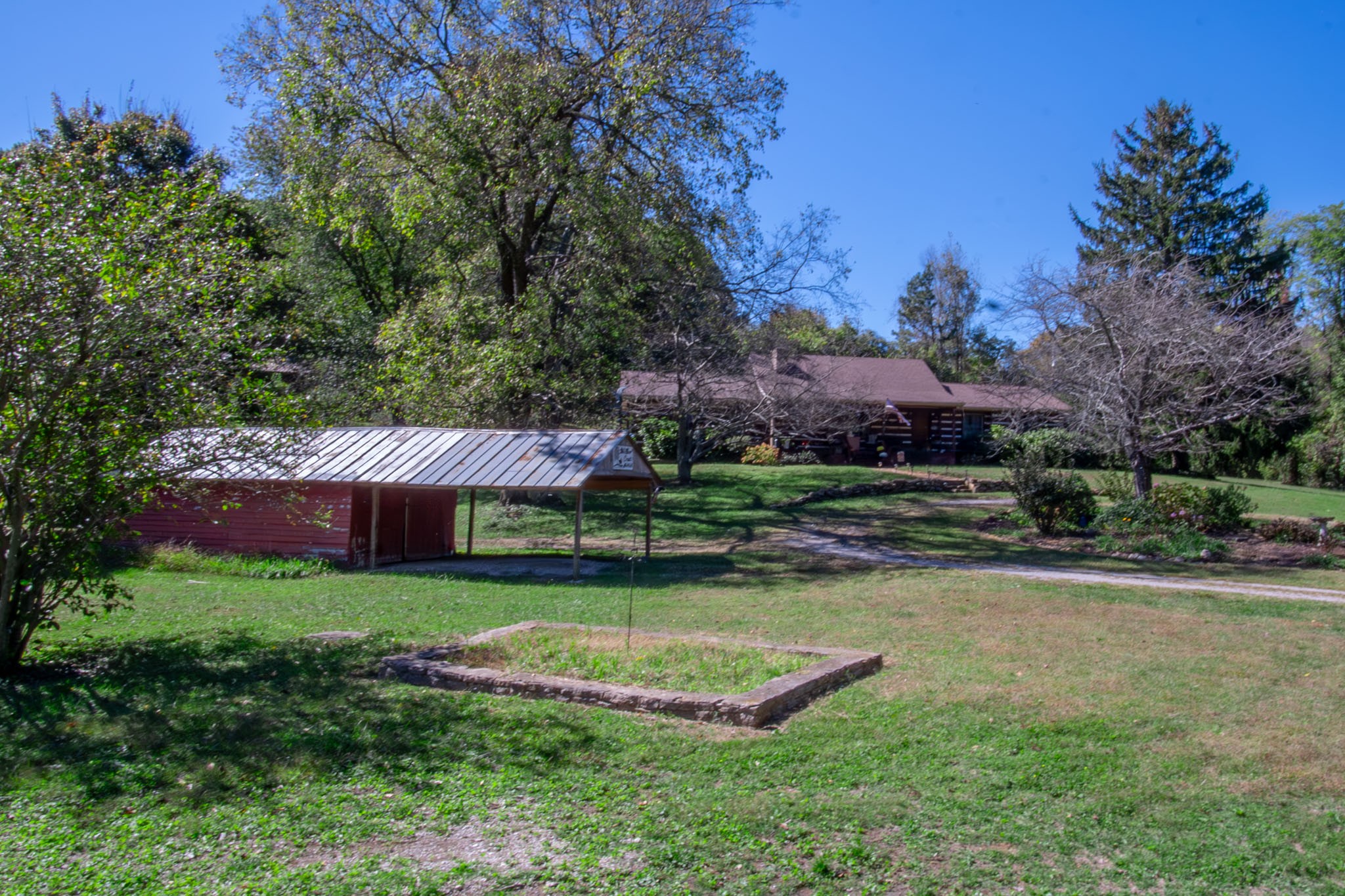 a view of a house with swimming pool and yard