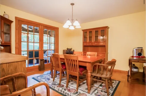 a view of a room with wooden floor and furniture