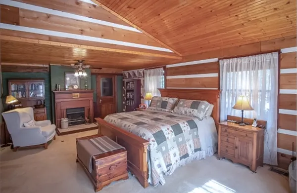 a view of a house with a tree and wooden fence