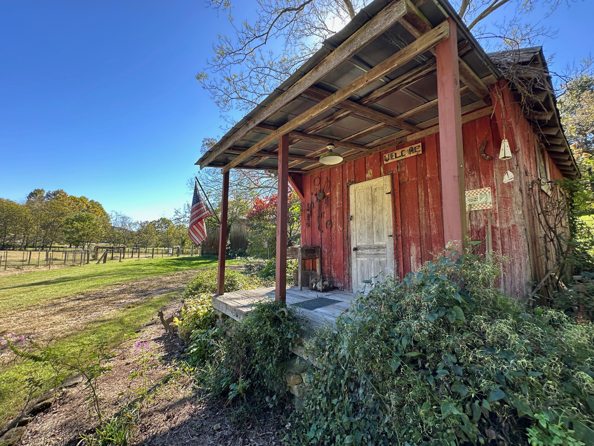 6861 Arno-Allisona Road College Grove, TN 37046 - Photo 36 of 68 a view of a backyard with lawn chairs under an umbrella