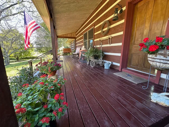 a room with furniture ceiling fan and a large window