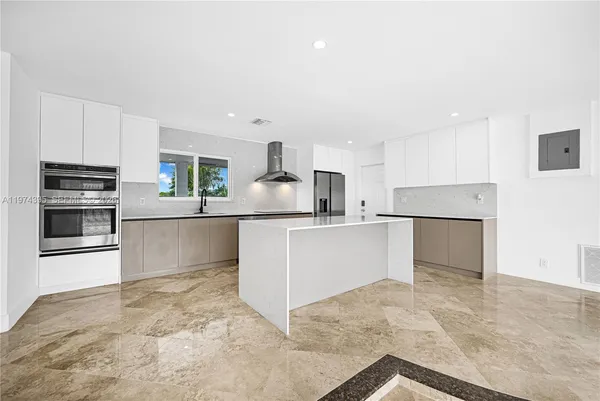 a large kitchen with cabinets and stainless steel appliances