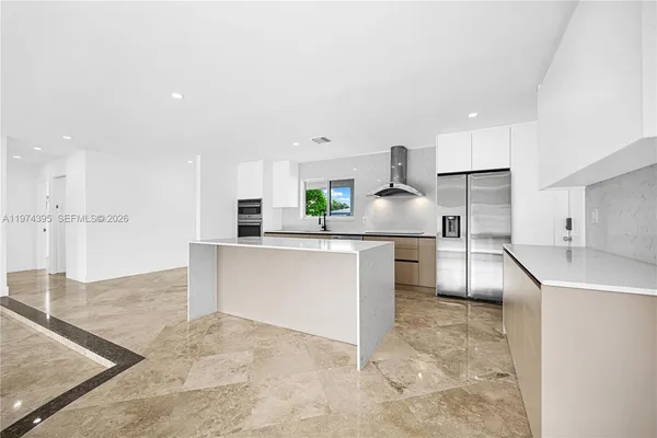 a kitchen with stainless steel appliances cabinets a sink and a stove