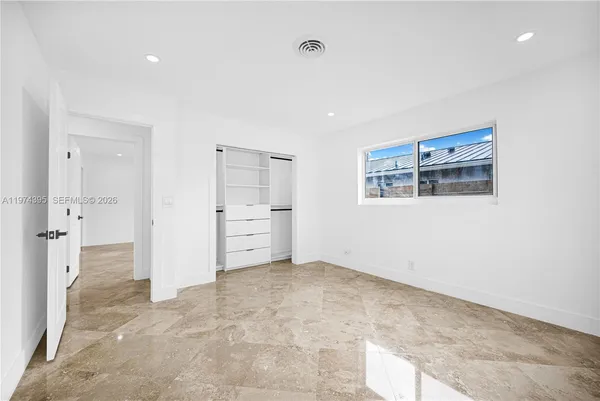 a view of an empty room with a cabinet
