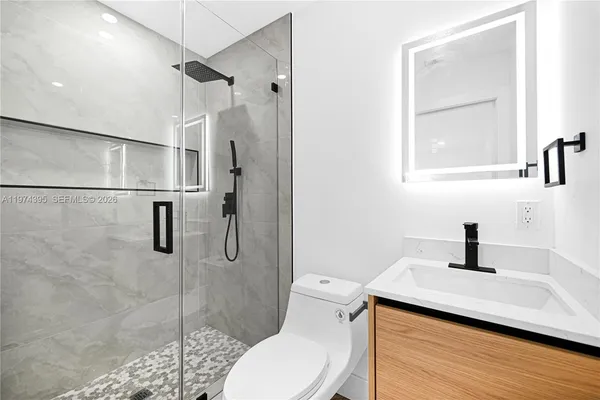 a bathroom with a sink toilet and shower