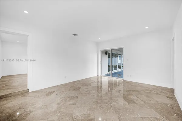 an empty room with windows and entrance