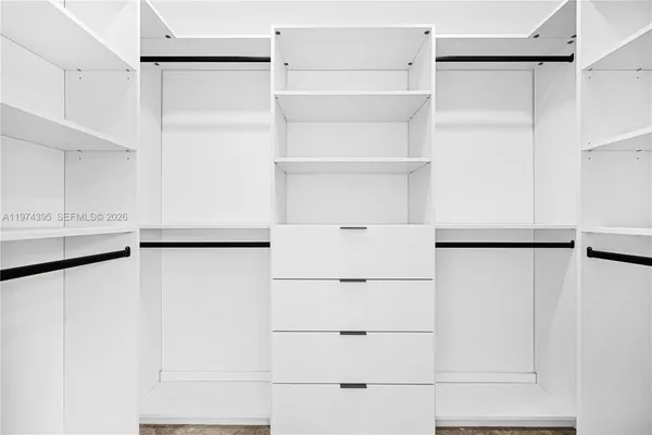a white refrigerator freezer and a stove sitting inside of a kitchen