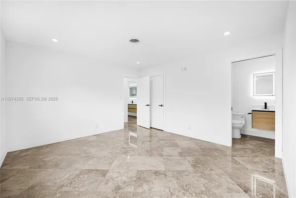 a view of empty room with kitchen