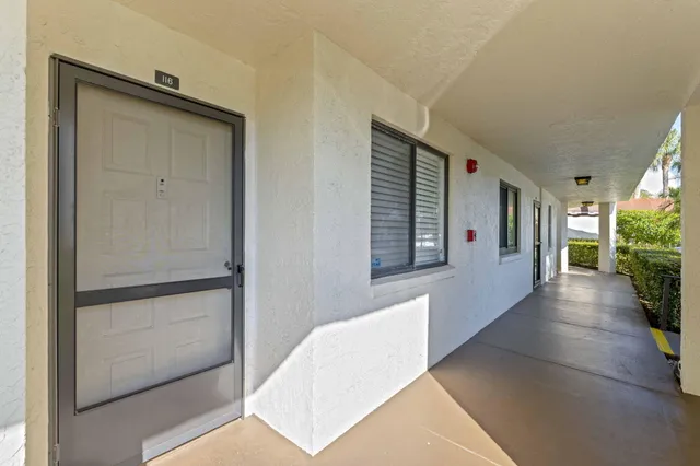 a view of a hallway with wooden floor and glass door
