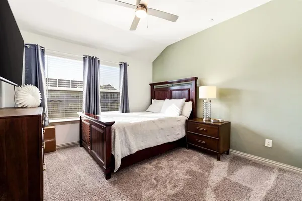 a bed room with a bed and a flat tv screen