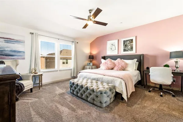 a bedroom with a bed chair and a window