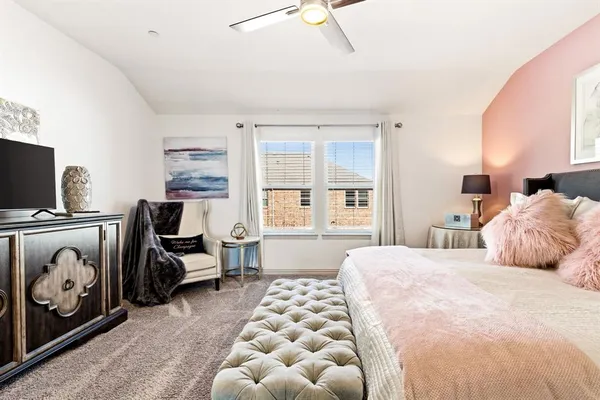 a bedroom with a bed and a couch