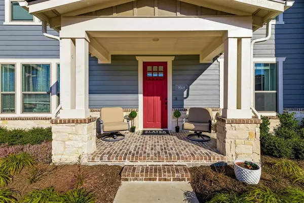 a front view of a house with outdoor seating