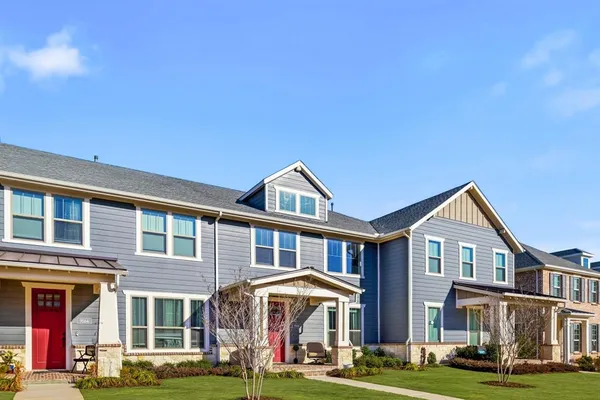a front view of a residential apartment building with a yard