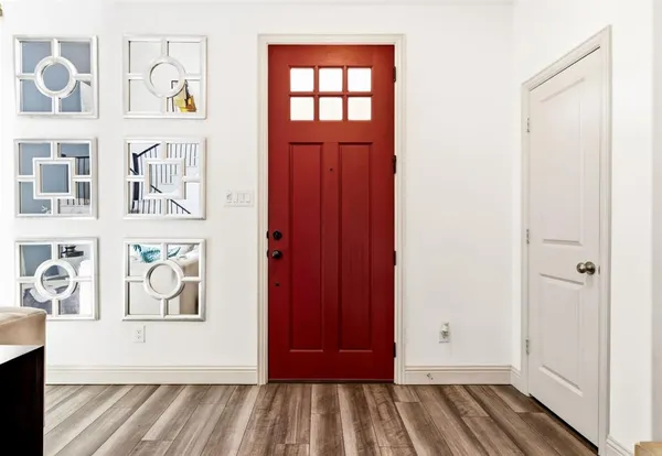 a view of an entryway with wooden floor