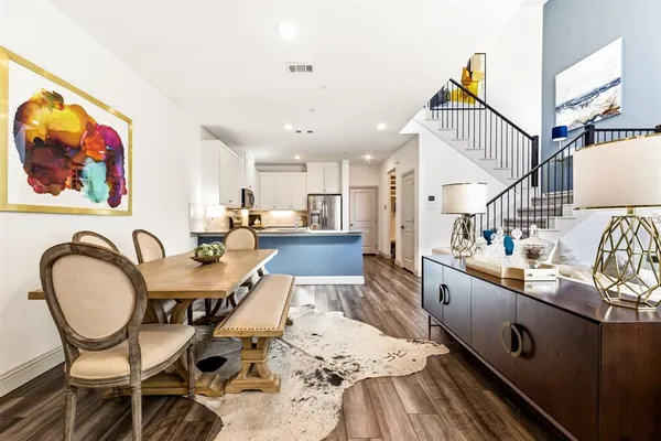 a dining room with furniture and wooden floor