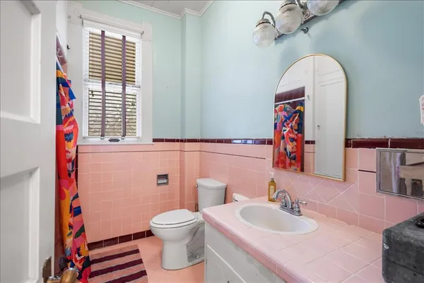 a bathroom with a sink a toilet and a mirror