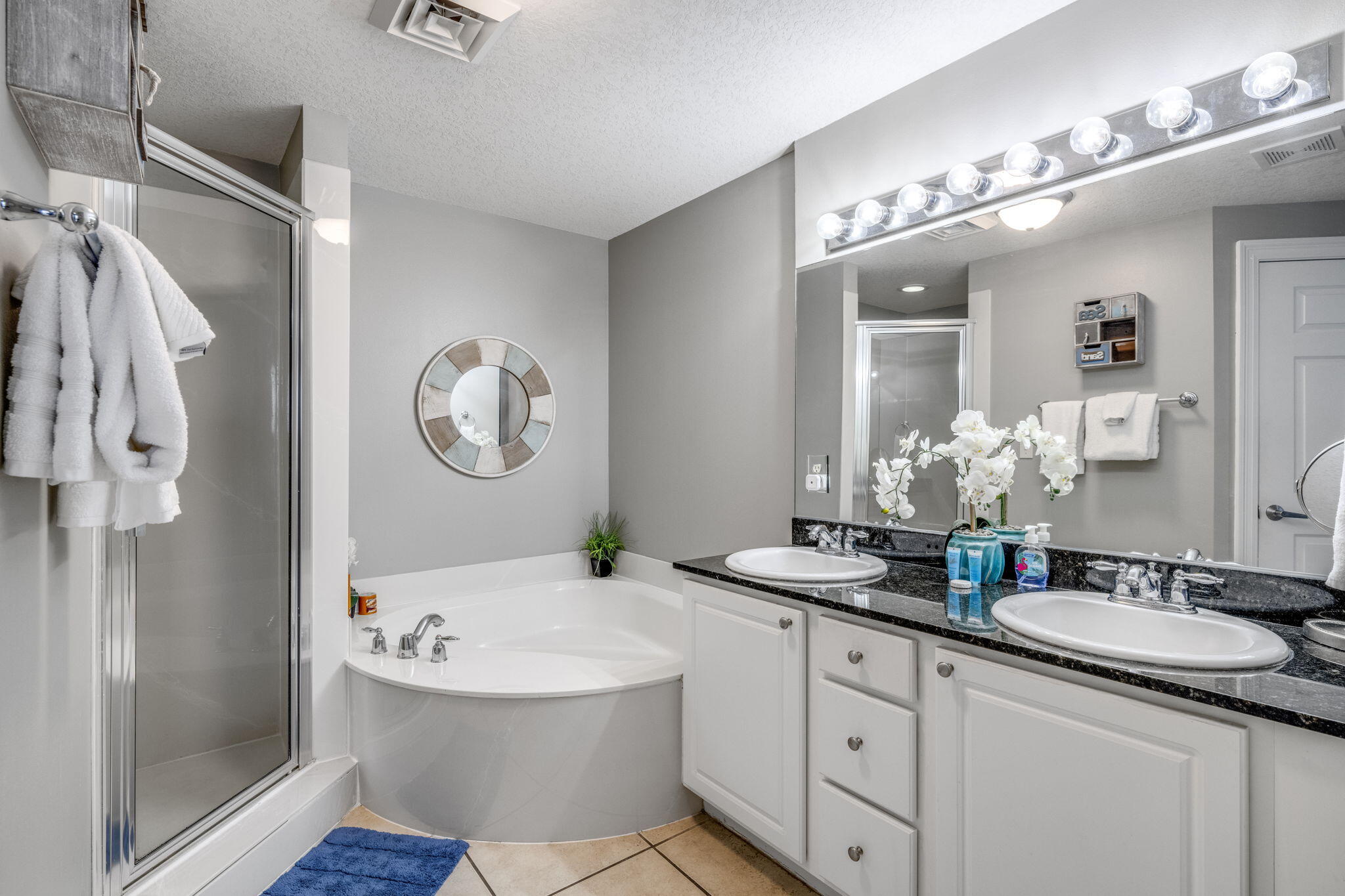 15817 Front Beach Road, Unit 21409 Panama City Beach, FL 32413 - Photo 13 of 23 a bathroom with a granite countertop sink mirror and a bathtub