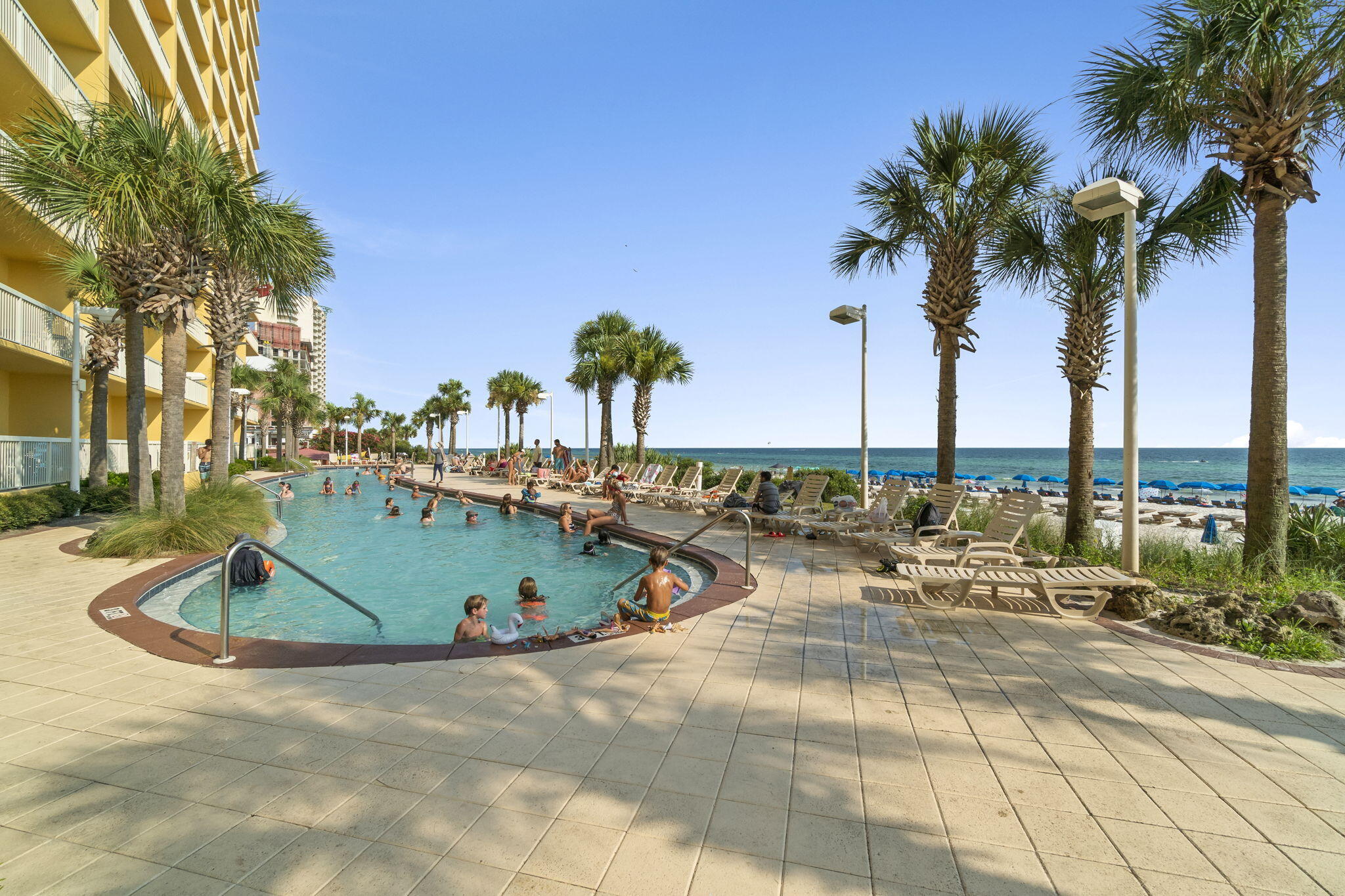 15817 Front Beach Road, Unit 21409 Panama City Beach, FL 32413 - Photo 20 of 23 a view of swimming pool with outdoor seating and palm trees