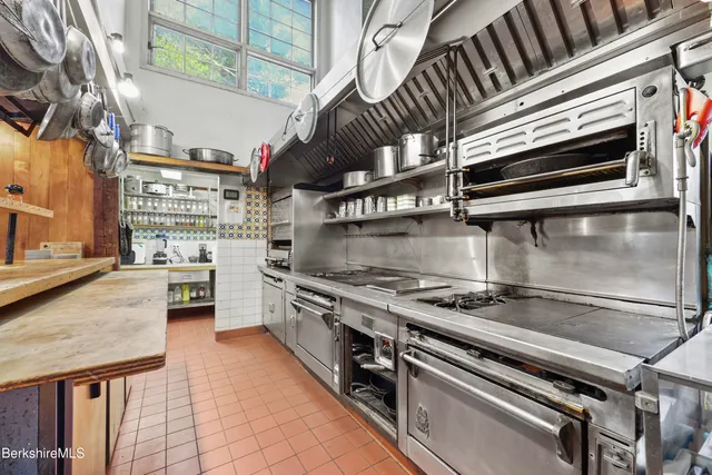 a kitchen with stainless steel appliances granite countertop a stove and a sink