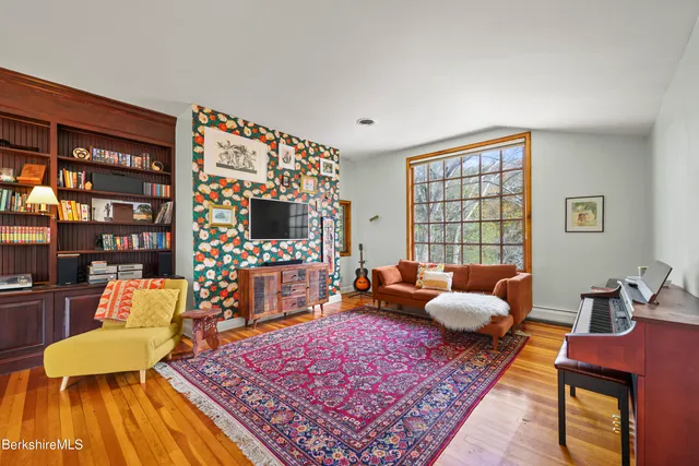 a living room with furniture a flat screen tv and a fireplace