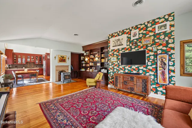 a living room with fireplace furniture and a book shelf